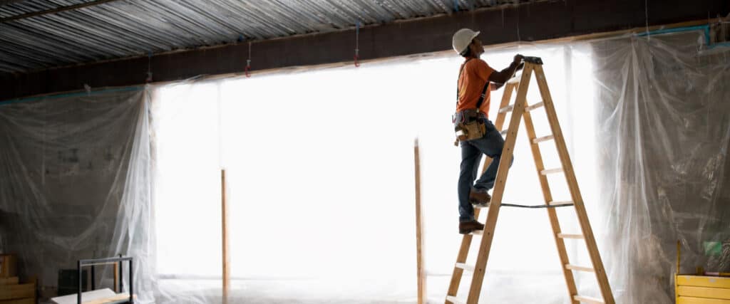 Wooden ladder on a construction site with lettering for direct marking on wood.