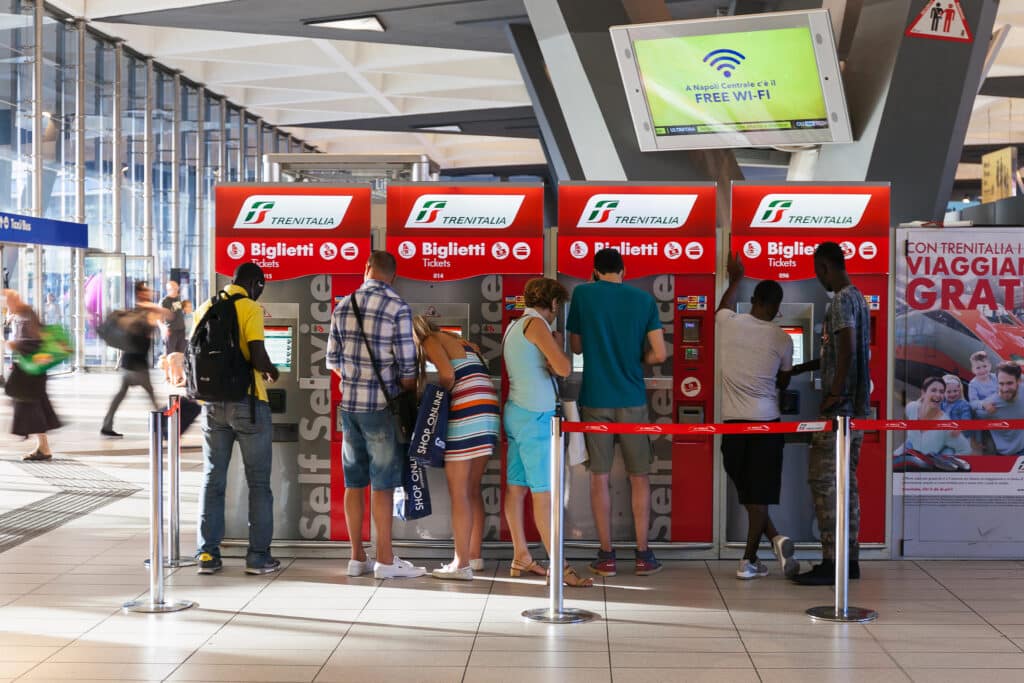 Ticket machines in the station with travelers